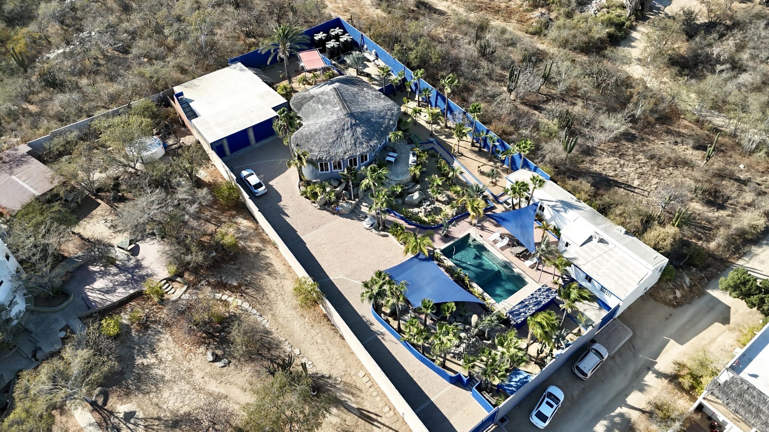 Cabo San Lucas Brisas Del Pac East Rare opportunity to own a large Cabo property in a prime location close to the highway, shopping, hospitals, and schools. This unique compound offers multiple buildings with room for expansion and incredible rental income potential.The main home is an authentic Cabo-tyle house at the center of the property. A separate casita can easily be converted into two condos, ideal for generating rental income. The property also includes a large garage and workshop, with a flat buildable pad above the garage--perfect for another home or condos with stunning for sale